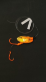 Orange gold plated in-line Kokanee lure